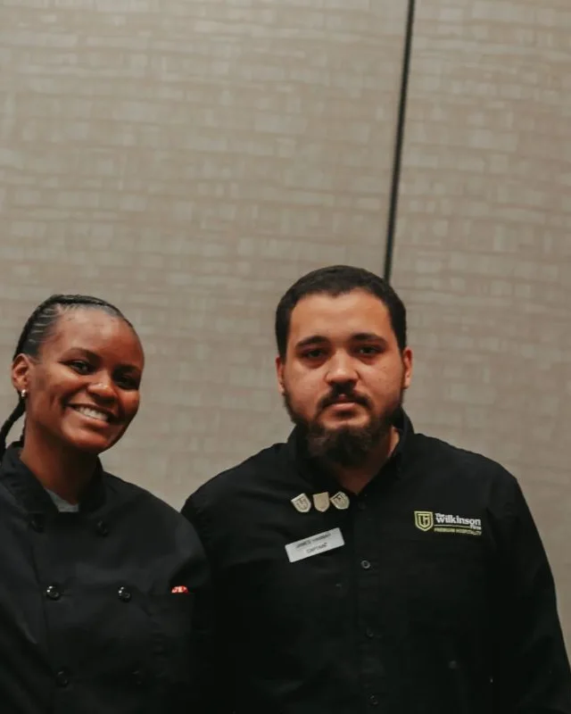Two TWF hospitality team members in TWF chef and captain jackets